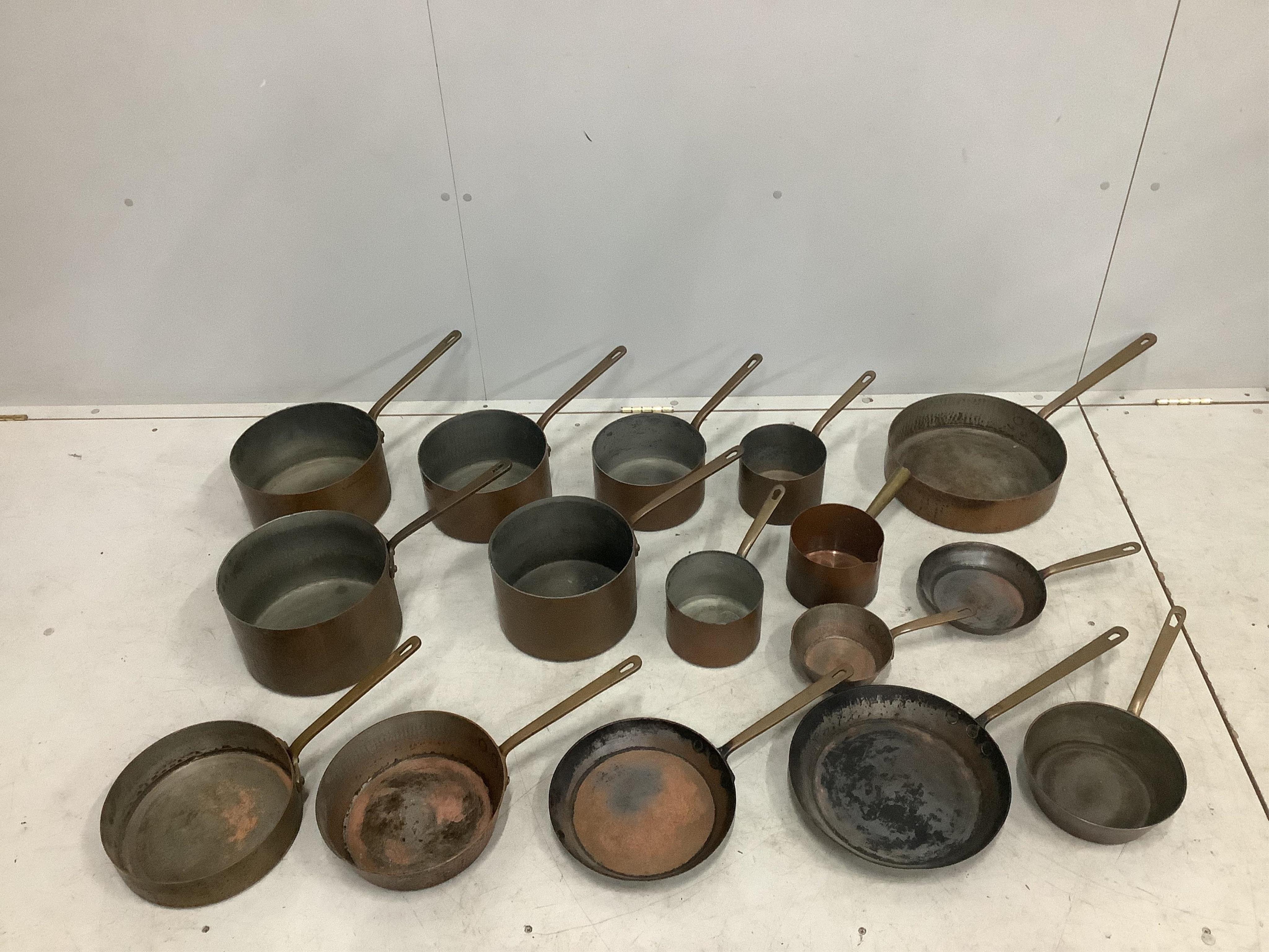 A quantity of assorted copper pans and covers. Condition - fair